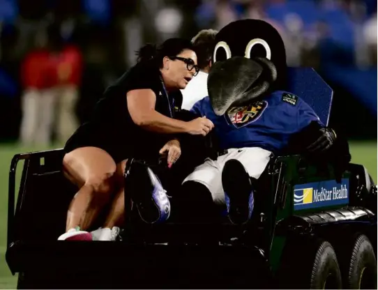  ?? NICK WASS/ASSOCIATED PRESS ?? Poe, the Baltimore Ravens’ mascot, was carted off the field with an apparent injury suffered in a halftime football game.
