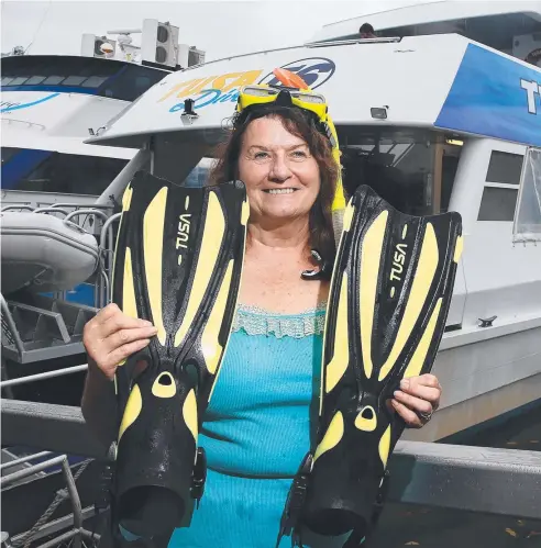  ?? Picture: JUSTIN BRIERTY ?? CAPTIVATIN­G EXPERIENCE: Aerospace engineer Marilyn Goepfert prepares for another Great Barrier Reef dive.