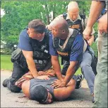  ?? AP PHOTO ?? Officers arrest suspect Willie Corey Godbolt on Sunday, following several fatal shootings Saturday in Lincoln County, Miss., officials said.