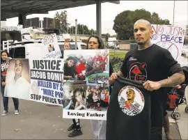  ??  ?? From right, Jesse Fernandez, brother, and Cindy Chavez, mother, protest the killing of their family member Jacob Dominguez by a San Jose police officer outside police headquarte­rs.