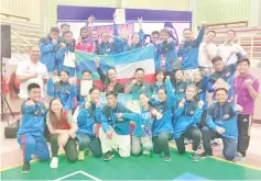  ??  ?? ALL SMILES: Jake (centre right, seated) with the state karate squad who bagged three gold, three silver and seven bronzes to finish second overall in the national senior championsh­ip in Selangor yesterday.