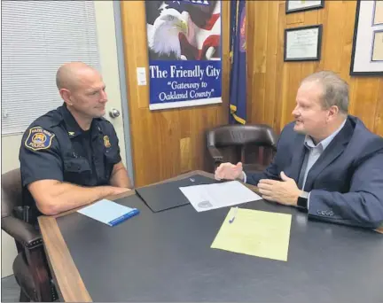  ?? PHOTO COURTESY OF CITY OF HAZEL PARK ?? Hazel Park City Manager Ed Klobucher, right, talkswith Police Chief Brian Buchholz at City Hall. Klobucher says community policing efforts and residents’ support of police have created a bond that hasmade the city safer andmore stable.