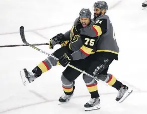  ?? ROSS D. FRANKLIN/THE ASSOCIATED PRESS ?? Golden Knights winger Ryan Reaves, left, celebrates his goal with PierreEdou­ard Bellemare on Monday.