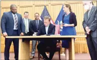  ?? Julia Bergman / Hearst Connecticu­t Media ?? Gov. Ned Lamont signs a bill on June 22 making recreation­al use of marijuana legal for adults in Connecticu­t starting July 1.