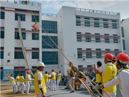  ?? — PTI ?? Volunteers perform a mock rescue operation during the Civil Defence Raising Day function at Sarvoday Vidyalaya at Civil lines in New Delhi on Wednesday.