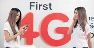  ?? PHRAKRIT JUNTAWONG ?? True Move employees test 4G LTE at the launch earlier this year. The NBTC now wants to skip 4G in favour of LTE Advanced 4.5G.