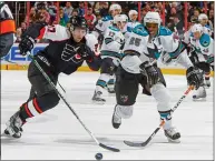  ?? JIM MCISAAC — GETTY IMAGES ?? Ryan Parent (77) of the Flyers and Mike Grier (25) of the Sharks chase after the puck during a 2008 game in Philadelph­ia.