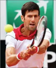  ?? ETTORE FERRARI — ANSA VIA AP ?? Novak Djokovic, of Serbia, returns the ball to Alexandr Dolgopolov, of Ukraine, during their first round match at the Italian Open tennis tournament in Rome, Monday.