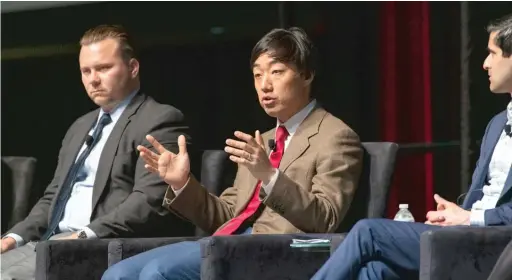  ?? TYLER PASCIAK LARIVIERE/SUN-TIMES ?? Bally’s Corp. CEO Soo Kim (center) speaks at a public meeting Thursday on the casino proposed for the River West neighborho­od.