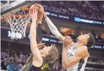  ?? ?? The Spurs’ Victor Wembanyama, right, blocks a shot by Utah Jazz forward Lauri Markkanen during a March 27 game in Salt Lake City. Wemby, a rookie, is in the discussion for Defensive Player of the Year.