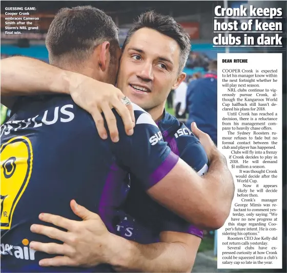  ??  ?? GUESSING GAME: Cooper Cronk embraces Cameron Smith after the Storm’s NRL grand final win.