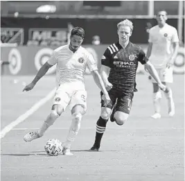  ?? JOHN RAOUX/AP ?? Inter Miami defender Nicolas Figal, left, passes the ball in front of New York City FC midfielder Gary Mackay-Steven, right, during the second half of an MLS match, July 20, 2020, in Kissimmee.