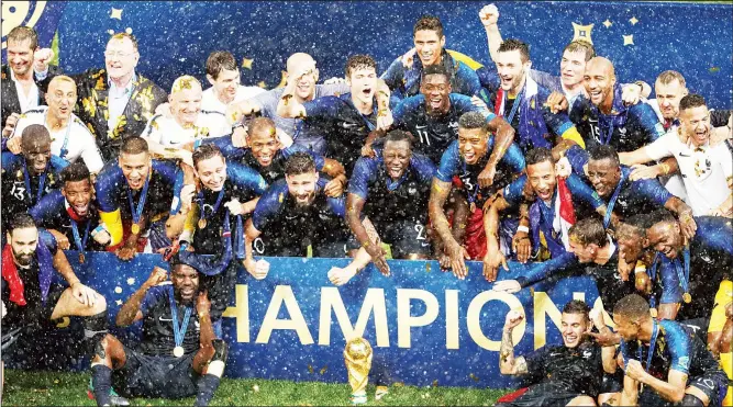  ?? (AFP) ?? France team players pose with the trophy as they celebrate during the trophy ceremony after winning the Russia 2018 World Cup final football match between France and Croatia at the Luzhniki Stadium in Moscow on July 15.