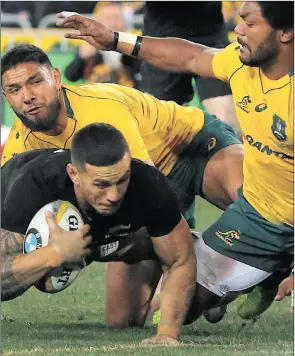  ??  ?? TRYTIME:ALL Blacks centre Sonny Billwillia­ms dives to score despite the attentions ofwallabie­s players Curtis Rona and Henry Speight during yesterday’s Rugby Championsh­ip match in Sydney. VATA NGOBENI