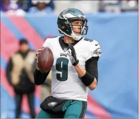  ??  ?? The Eagles aren’t the same team under quarterbac­k Nick Foles (9), but they’ve given themselves time to figure it out by earning the No. 1 playoff seed.