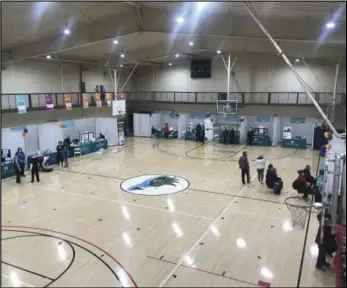  ?? Staff photo/Corey Maxwell ?? In previous years, the entire gym floor would be full of booths at the Grand Lake Health fair, but this year the center of the floor was left open, allowing for extra space for community members to social distance.