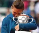  ??  ?? An emotional Halep with the French Open trophy