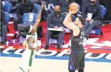  ?? MATT SLOCUM/AP ?? 76ers’ Ben Simmons goes up for a three-point shot against the Bucks’ Jrue Holiday on Wednesday in Philadelph­ia.