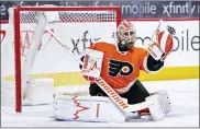  ?? CHRIS SZAGOLA — THE ASSOCIATED PRESS ?? Philadelph­ia Flyers’ Alex Lyon makes the glove save during the second period of an NHL hockey game against the Washington Capitals, Saturday, April 17, 2021, in Philadelph­ia.