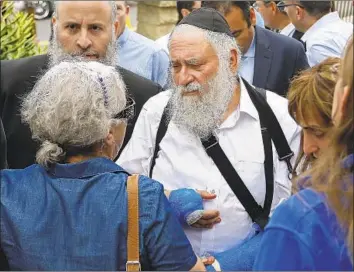  ?? K.C. Alfred San Diego Union-Tribune ?? RABBI YISROEL GOLDSTEIN meets with members of Chabad of Poway on Sunday, one day after a gunman entered the synagogue and killed a congregant and injured three others, including Goldstein.