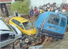  ?? — AFP ?? Cars are piled up in a street after being swept away by torrential rains in the city of Mohamedia near the Tunisian capital Tunis on Thursday.