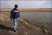  ?? BRITTANY PETERSON — THE ASSOCIATED PRESS ?? Don Schneider stands in front of an augmentati­on pond on his property in Ovid, Colo., on Friday. He pumps water from a shallow aquifer for irrigation, and uses supply from the South Platte River to replenish the wells.