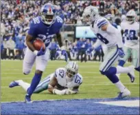  ?? FRANK FRANKLIN II - THE ASSOCIATED PRESS ?? New York Giants’ Wayne Gallman, left, scores a touchdown during the second half of an NFL football game against the Dallas Cowboys, Sunday, Dec. 30, 2018, in East Rutherford, N.J.