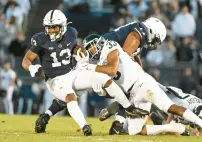  ?? BARRY REEGER/AP ?? Michigan State cornerback Kendell Brooks tackles Penn State running back Kaytron Allen during the first half of a Nov. 26 game in State College.