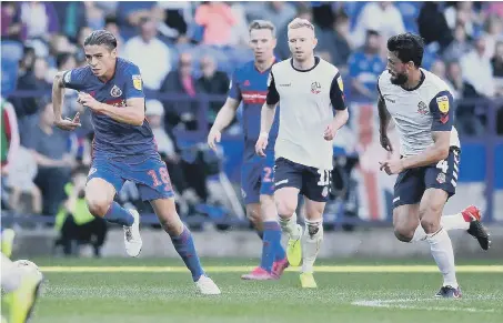  ??  ?? George Dobson charges forward against Bolton Wanderers on Saturday.