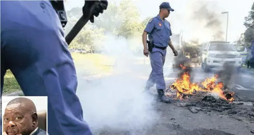  ?? PICTURE: EPA ?? Protesting students have had enough and their anger is burning hot. In response, Minister of Higher Education Blade Nzimande, left, has cautioned that no university’s fees should be raised by more than 8% for 2017.