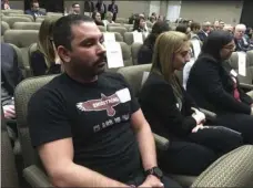  ??  ?? Shane Fedderman (left) a 1998 graduate of Marjory Stoneman Douglas High School in Parkland, Fla., watches as families of mass shooting victims urge California’s public pension funds to stop investing in retailers of assault weapons in Sacramento on...