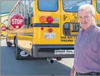  ?? 46#.*55&% 1)050 ?? Summerside school bus driver Pat Flood is shown with a bus equipped with the new dual-stop arm that will add another layer of safety for children.