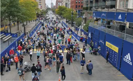  ?? ?? AT THE FINISH LINE: People walk around the Boston Marathon finish line on Boylston Street on Sunday.