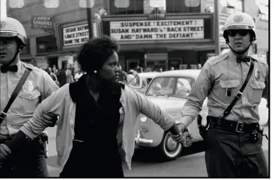  ??  ?? Above top Bruce documented the American civil rights movement over a five-year period. In this 1963 shot, a demonstrat­or is arrested in Birmingham, Alabama.