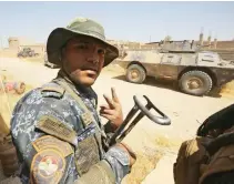  ??  ?? An Iraqi soldier flashes the V-sign as troops advance through Tal Afar's Al-Wahda district during an operation to retake the city from Daesh. (AFP)