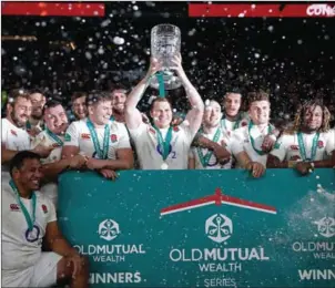  ??  ?? England captain Dylan Hartley lifts the Cook Cup after his side beat Australia 37-21 in the Test match at Twickenham on Saturday.