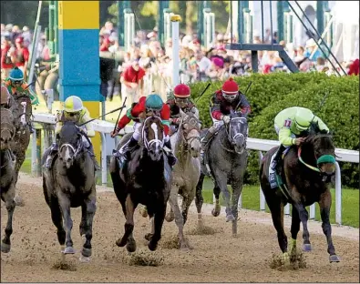  ?? Arkansas Democrat-Gazette/MITCHELL PE MASILUN ?? Classic Empire (left, in gray and yellow silks) and jockey Julien Leparoux rallied past Conquest Mo Money and Jorge Carreno in the final strides to win Saturday’s $1 million Grade I Arkansas Derby before an estimated crowd of 62,500 at Oaklawn Park in...