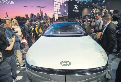  ?? THOMAS LOHNES GETTY IMAGES FOR HYUNDAI ?? Spectators take a look at the “45” electric vehicle concept after its unveiling at the 2019 IAA Frankfurt Auto Show on Tuesday.