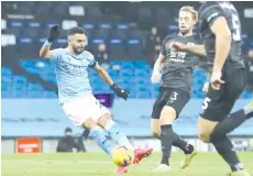  ?? - AFP photo ?? Mahrez (left) scores his team’s first goal during the match between Manchester City and Burnley at the Etihad Stadium.