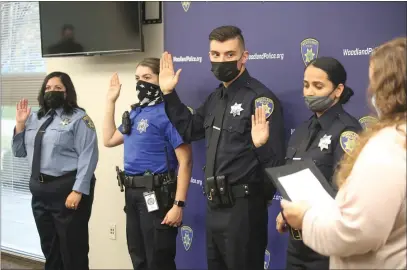  ?? CARLOS GUERRERO/DAILY DEMOCRAT ?? New Woodland Police Department hires from left to right; Records Specialist Mariana Chavez, Community Service Officer Zulema Lopez, new police officers Liviu Sirbu and Harshbir Bansal.