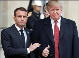  ??  ?? ARM-ISTICE: A reluctant thumbs up as Mr Macron aims higher