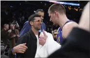  ?? MARK J. TERRILL — THE ASSOCIATED PRESS ?? Tennis player Novak Djokovic, left, greets Nuggets center Nikola Jokic after the Nuggets defeated the Lakers 124-114 on March 2 in Los Angeles.