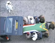  ?? Phil Magakoe/Associated Press ?? The flag-draped casket carrying the remains of Winnie Madikizela-Mandela arrives Saturday at the Orlando Stadium in Soweto, South Africa. Ms. Madikizela-Mandela died April 2 at the age of 81.