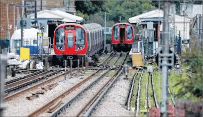  ?? AP PHOTO ?? A police forensic tent stands setup on the platform next to the train, at left, on which a homemade bomb exploded at Parsons Green subway station in London, England,Friday.