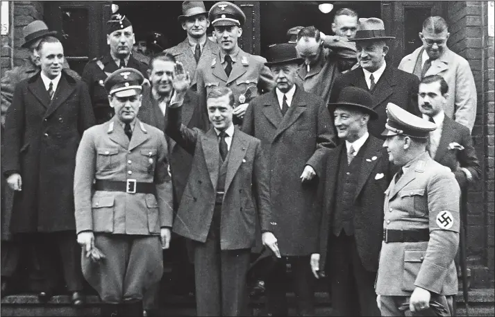  ??  ?? VIP guest: Surrounded by uniformed Nazi party officials and engineerin­g chiefs, Edward gives a Nazi salute on an inspection of a coal mine during his tour of Germany in 1 37