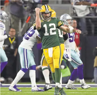  ?? TOM PENNINGTON/GETTY IMAGES ?? Packers quarterbac­k Aaron Rodgers celebrates after throwing a touchdown pass in the third quarter against the Cowboys.