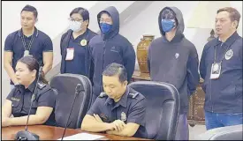  ?? ?? Bureau of Immigratio­n spokespers­on Dana Sandoval (seated, left) presents Shimoeda Saito (standing, third from left, and left photo) and Sugano Kazushi prior to their deportatio­n yesterday.