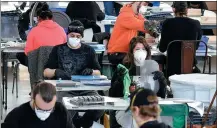  ?? ANGELA WEISS / AFP ?? Workers at Brooklyn Navy Yard manufactur­e face shields on Thursday to help in the COVID-19 struggle in New York City.