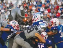  ?? SUN FILE (2017) ?? Bishop Gorman’s Brevin Jordan, holding the football, ends up upside down atop a pile while trying to reach the end zone in a game against Liberty High School. Jordan graduates Sunday and will board a plan Monday, bound for Florida to play football at the University of Miami.