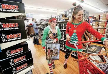  ?? [AP PHOTOS] ?? Sara Wernimont, left, and Christina Wernimont, both of Dubuque, Iowa, look for deals at Theisen’s Home-Farm-Auto in Dubuque, Iowa, on Friday. Black Friday has morphed from a single day when people got up early to score doorbuster­s into a whole season...